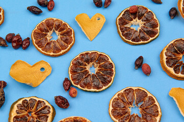 hearts from zest, oranges and rose hips on a light background