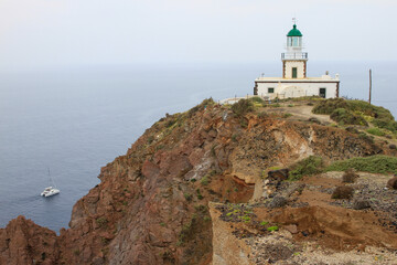 Fototapeta na wymiar Akrotiri Lighthouse with mist and sea, Santorini, Greece 