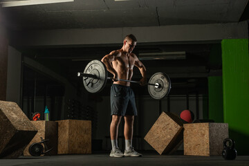 Plakat Fit strong shirtless athlete doing squats. Hardcore Cross-fit workout concept.