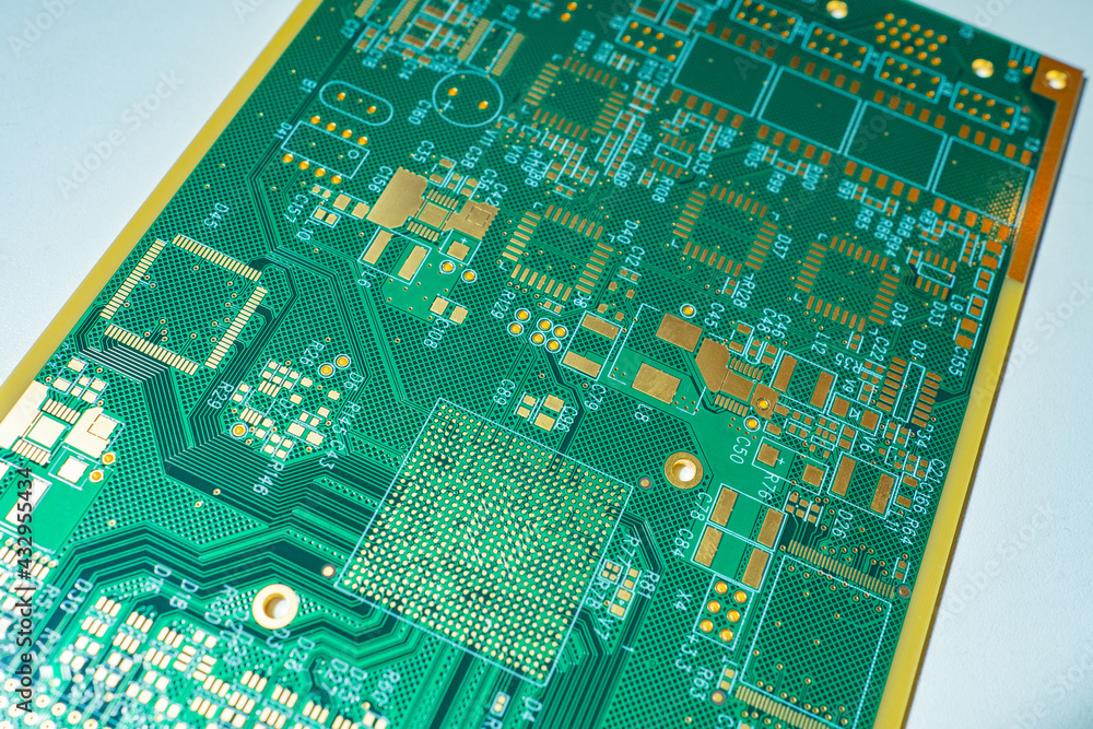 Fototapete the green printed circuit board is located diagonally. a board for attaching microchips. production 
