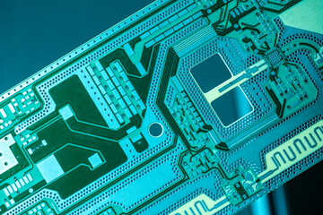 Green background with printed circuit board. Printed circuit board close-up. The concept of radio electronics. PCB without microchips. Development of microchips for the electronics industry.