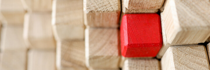 Pyramid of beige wooden cubes, one of them is red