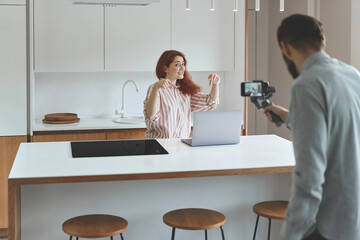 Obraz premium Front view of business couple recording coaching workshop at smartphone and steadycam