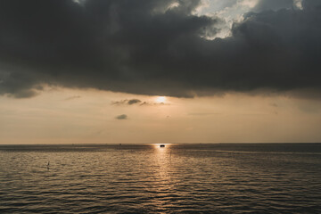 Tiny fishing hut in the middle of sunset and the sea.