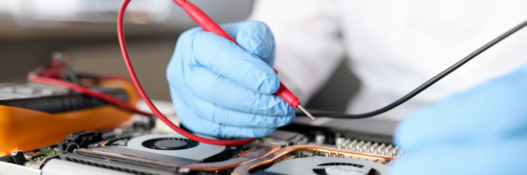 Gloved Handyman Repairs Motherboard. Maintenance And Repair Of Computer Equipment