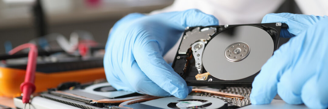 Gloved master holds a hard drive closeup