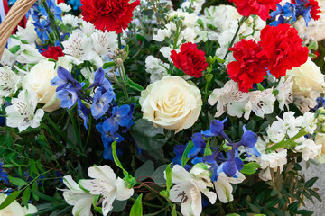Flowers decor from a funeral wreath. In memory of the war dead, the wrecked, the buried. Flowers on the grave. Victory Day. Memorial Day.