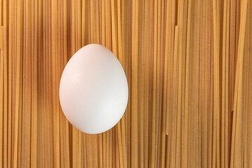 White egg on the raw pasta