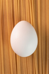 White egg on the raw pasta