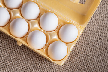 White egg carton on the brown background
