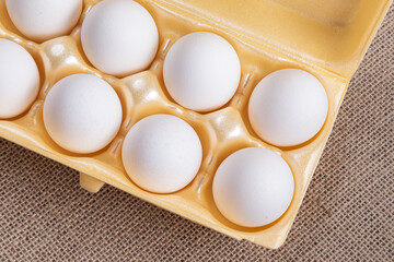 White egg carton on the brown background