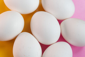 Eggs on the yellow and pink background