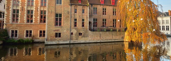 Panoramic view of the canal and traditional brick houses in a historical city center at sunset....
