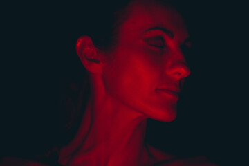 Portrait of a young woman in red light