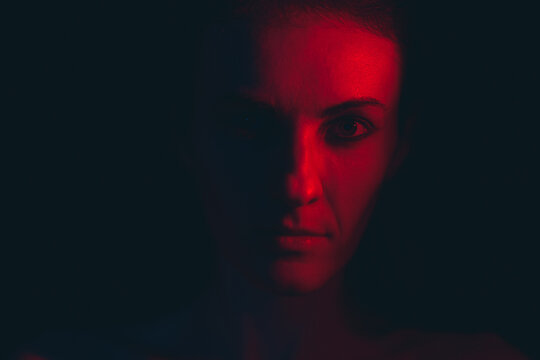 Portrait of a young woman in red light