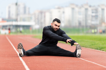 Young Fitness Man Runner Stretching Legs Before Run