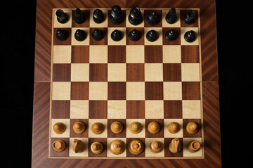 Black Chess piece over chessboard