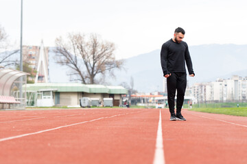 Fototapeta na wymiar Portrait of Sporty Man on Running Track
