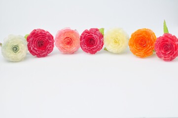 Artificial flowers made of fish scales on a white background.
