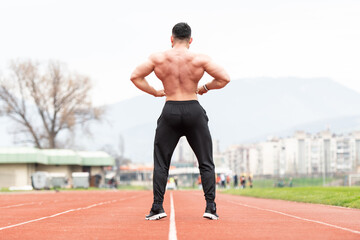 Portrait of Muscular Man Standing Strong Outdoors