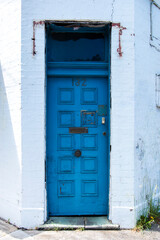 Charming and Rustic Blue Door in Old White Painted Brick Building