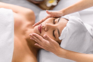 woman getting facial spa massage treatment at beauty spa salon