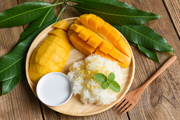 Ripe mango rice cooked with coconut milk, Asian Thai dessert tropical sweet mango peel and sliced...
