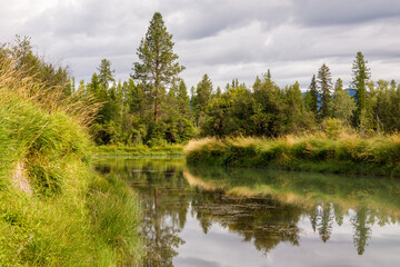 Fototapeta na wymiar slow peaceful river scene on a pleasant afternoon, Whitefish River, Montana