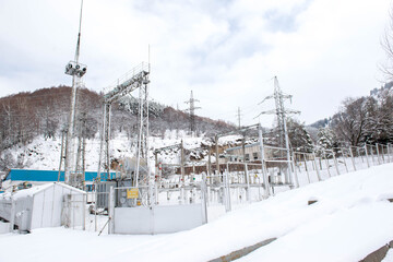 huge power plant in the mountains covered with snow