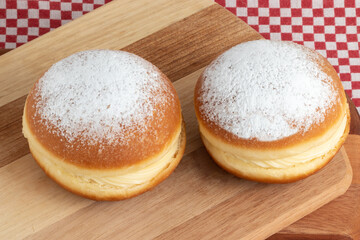 Two Berlin balls (Brazilian Sonho) on cutting board.