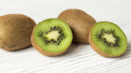 Juicy ripe kiwi on a wooden table, space for text