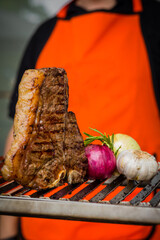 Grilled Meat T Bone Barbecue On Grill With Man Cooking