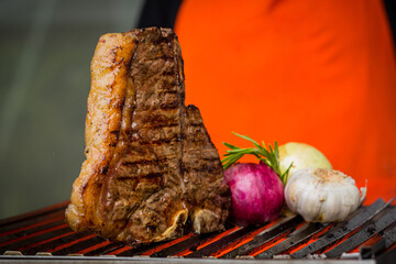 Grilled Meat T Bone Barbecue On Grill With Man Cooking BBQ