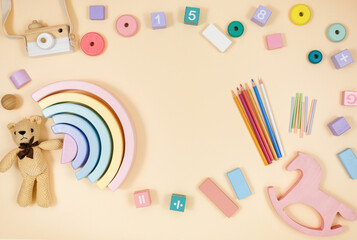 Wooden baby cubes on beige table. Educational toys blocks, arc, numbers. Toys for kindergarten, preschool or daycare. Copy space for text. Top view	