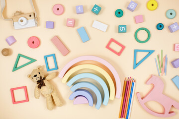 Wooden baby cubes on beige table. Educational toys blocks, arc, numbers. Toys for kindergarten, preschool or daycare. Copy space for text. Top view	