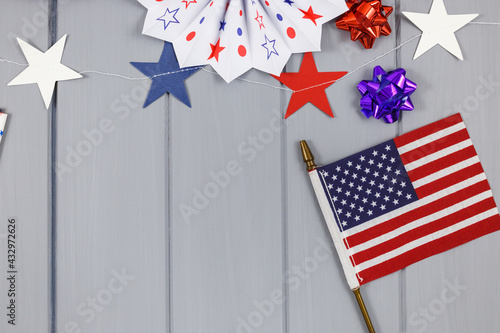 Decorations for 4th of July day of American independence, flag, candles, straws, paper fans. USA holiday decorations on a blue background, top view, flat lay