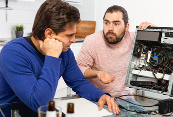 Men do not know how to repair a computer. High quality photo