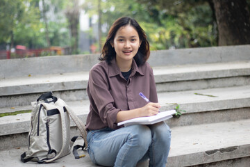 Young woman studying at the park.