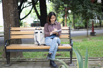 Young woman studying at the park.