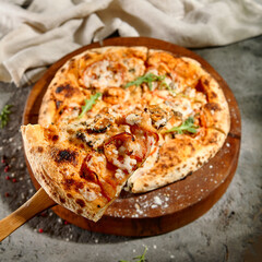 Italian Seafood Pizza - Pizza with mixed Seafood on wooden dish. Rustic seafood pizza on grey background with sunshine and harsh shadow.