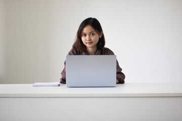 Portrait of beautiful young woman working in the office.