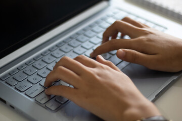 Hands of an office woman typing