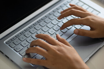 Hands of an office woman typing