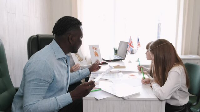 Africanm american man and female teacher teaching English on private lesson