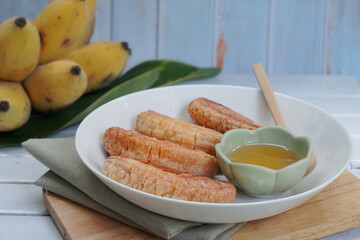 Thai grilled bananas serve with honey or coconut syrub. Selective focus and free space for text. Clean vegetarian food for good health. Shooting in studio for advertise.