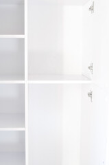 Empty white shelves of the cupbord organizer for clothes