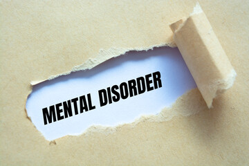 mental disorder word written under torn paper.