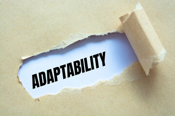 Adaptability word written under torn paper.