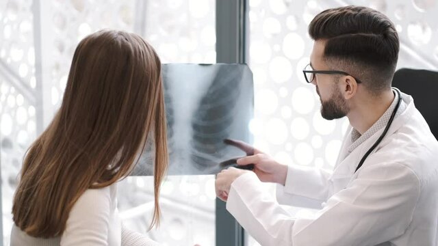 Man and woman look at xray of patient