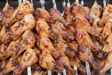 Fried chicken thighs on skewers. Food background concept.